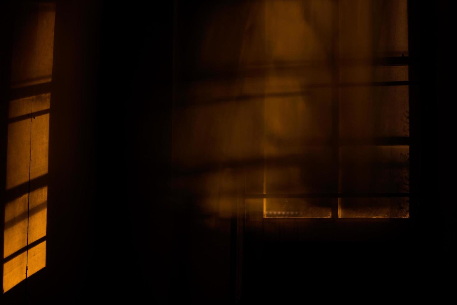Window blinds blur in dark room with light. photo