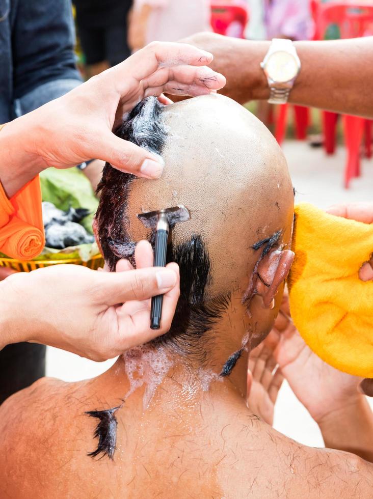 Monk hands are shaving heads. photo