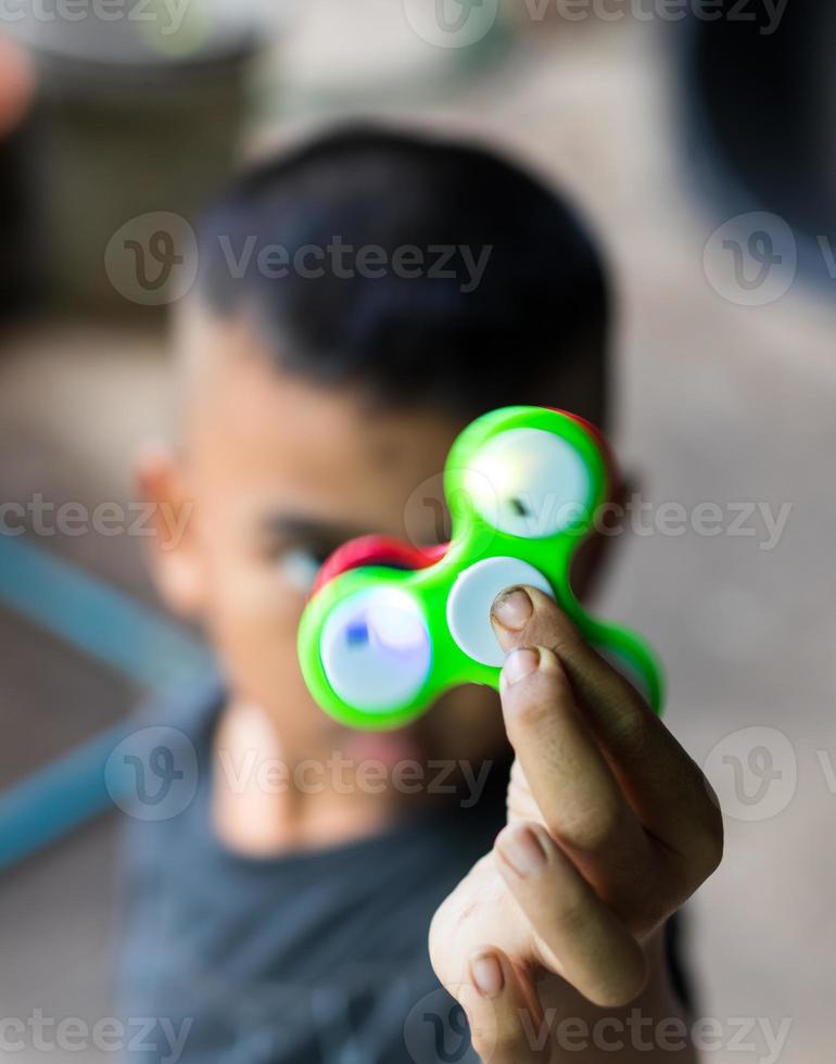 Green hand spinner in hand. photo