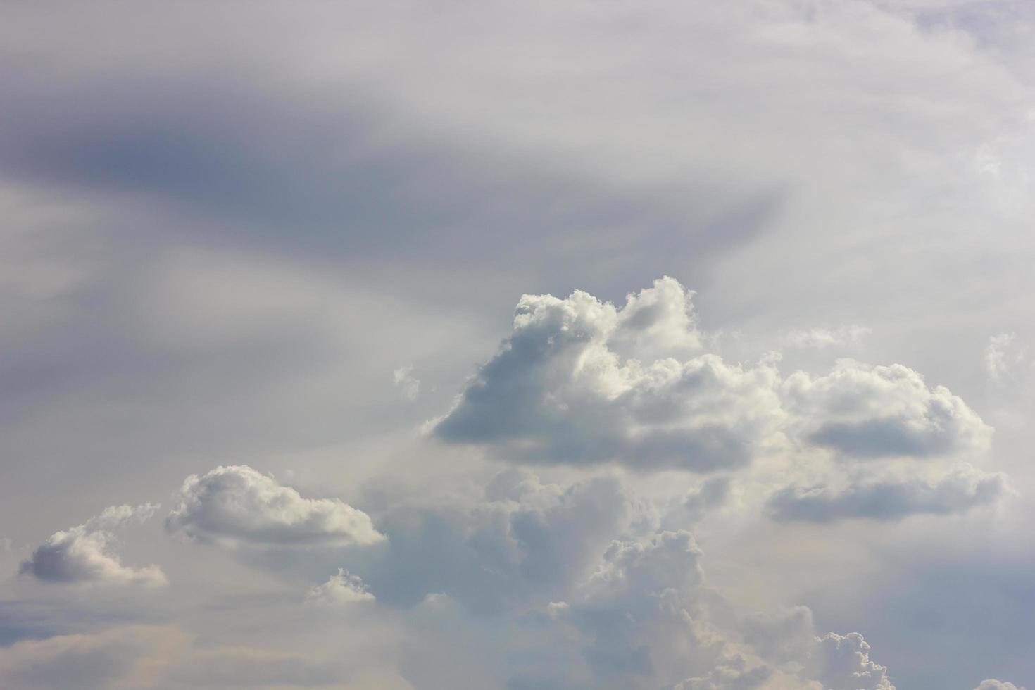 Fluffy clouds backlit scenery. photo