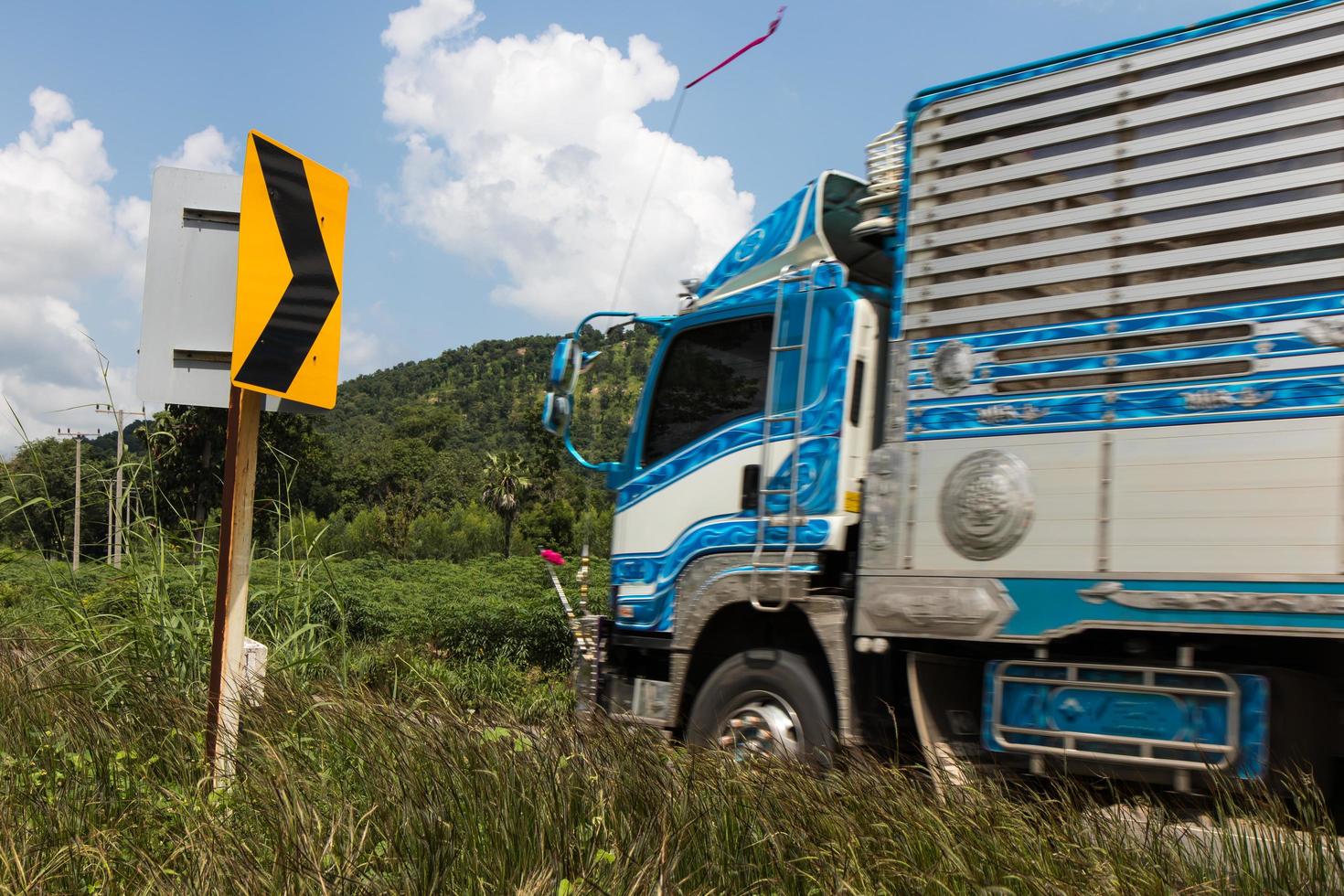 Signpost bends and trucks. photo