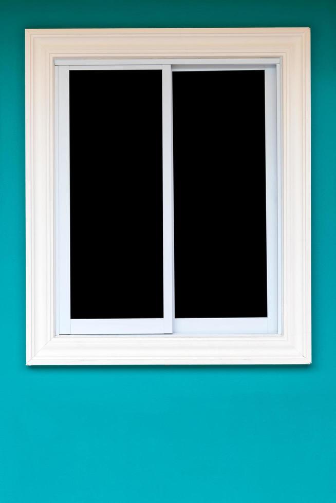 White windows in dark green walls. photo