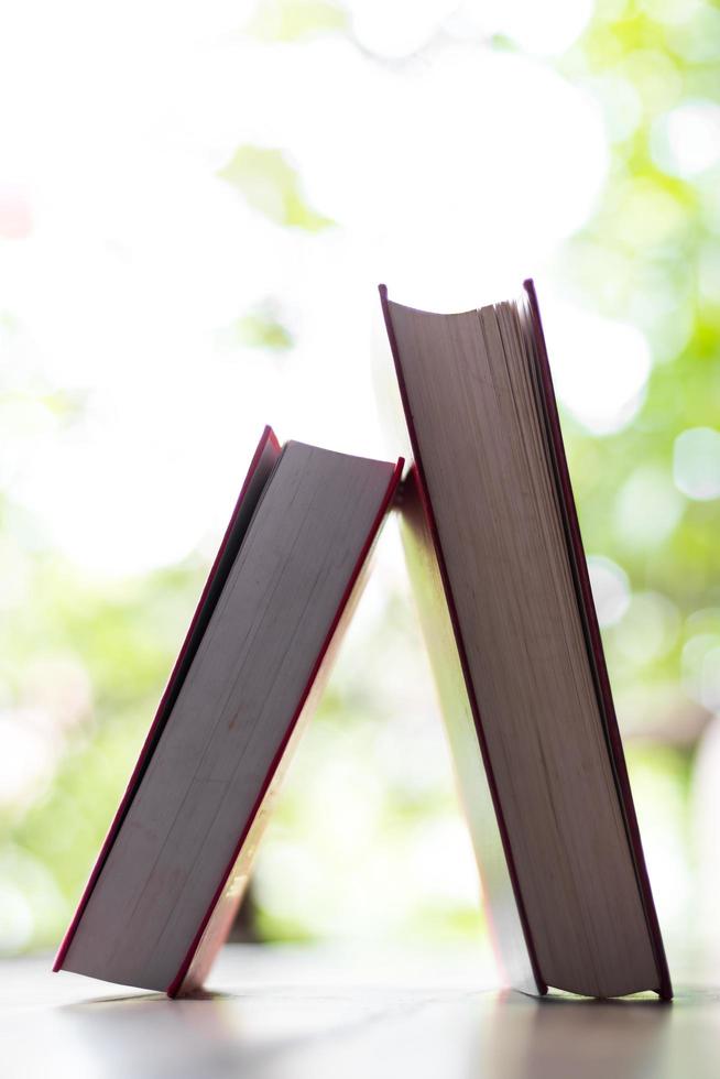 Hardcover books leaning on the table. photo