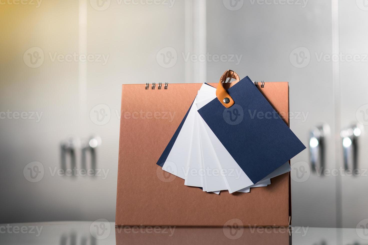 Notebooks and calendars are placed near the cabinet. photo