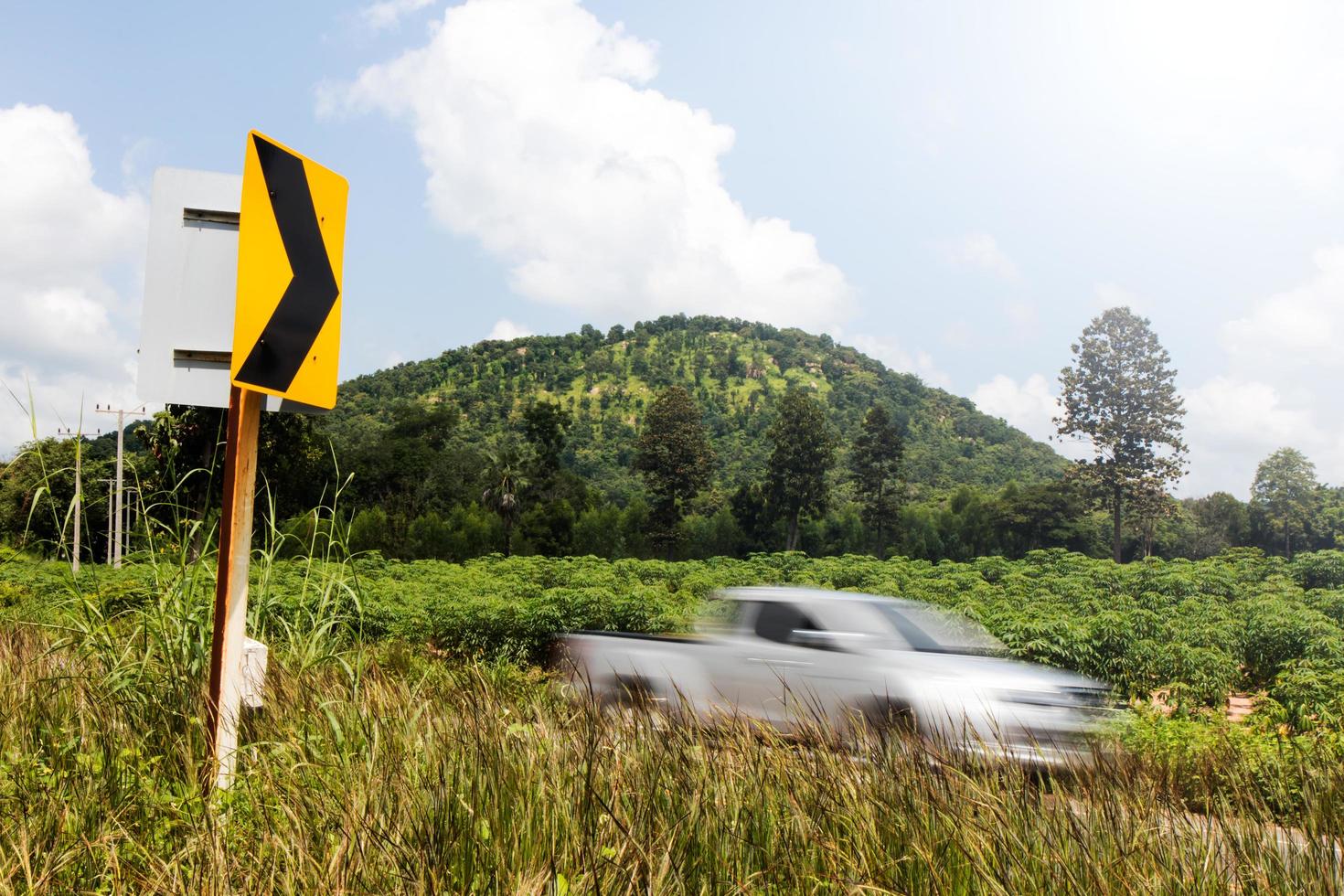 Signs curve with cars blurred hill. photo