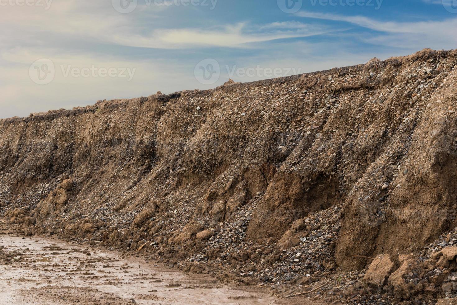 Soil eroded under dirt road. photo