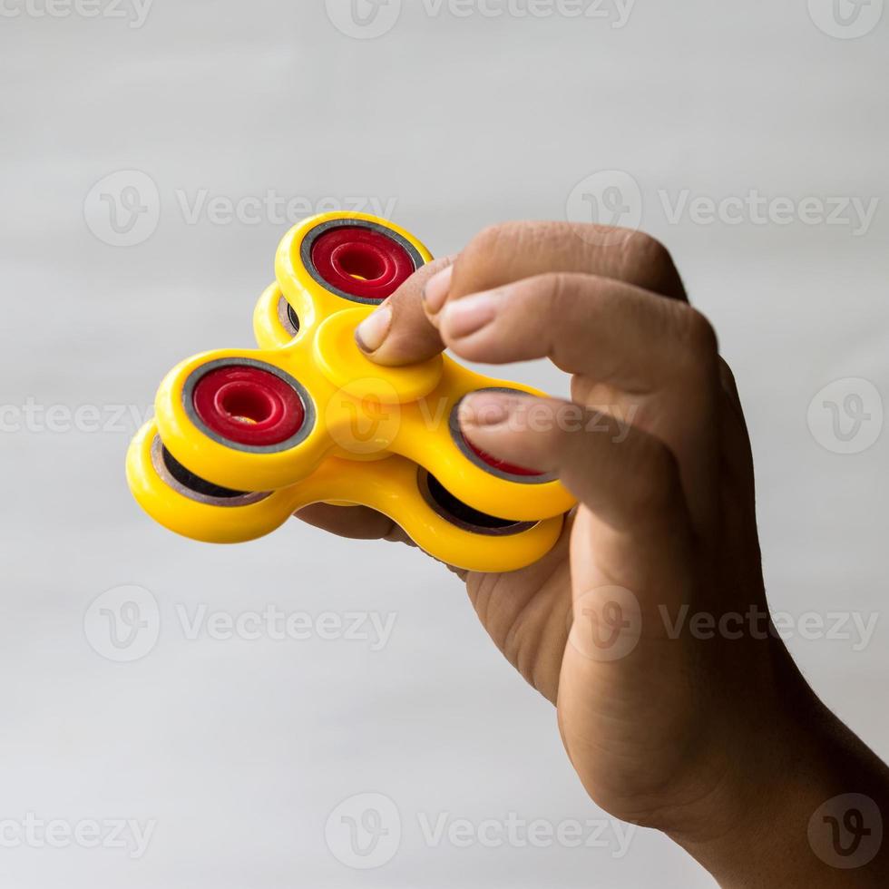 mano de bebé con spinner amarillo. 7519340 Foto de stock en Vecteezy