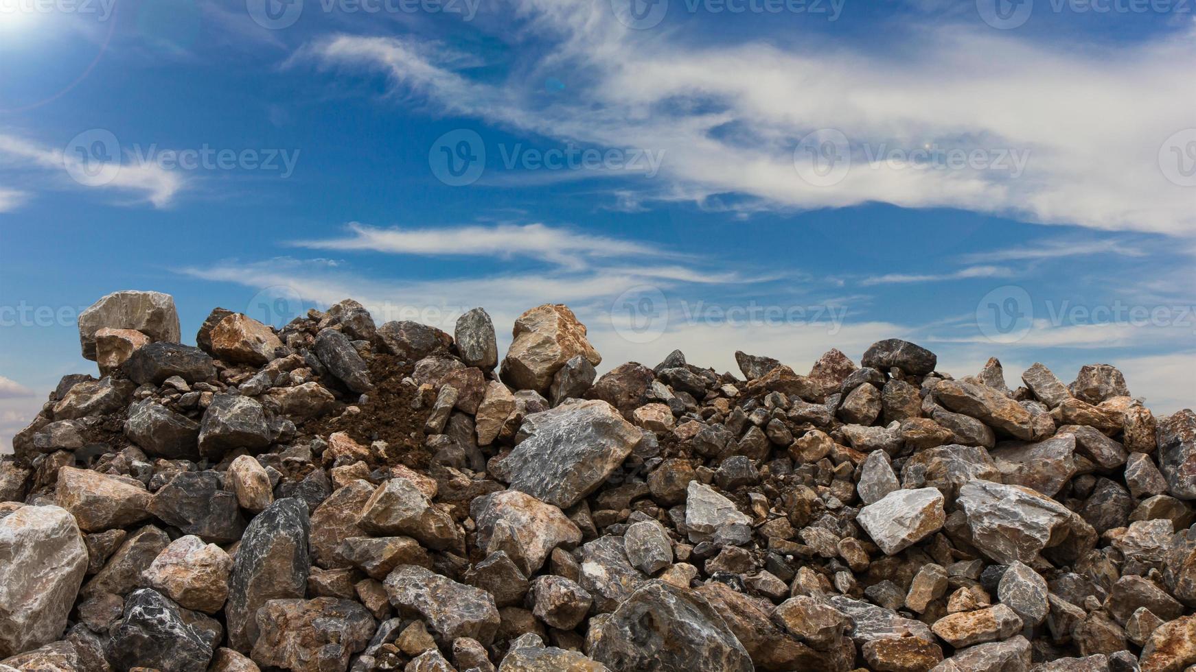 Granite pile with sky clouds. photo