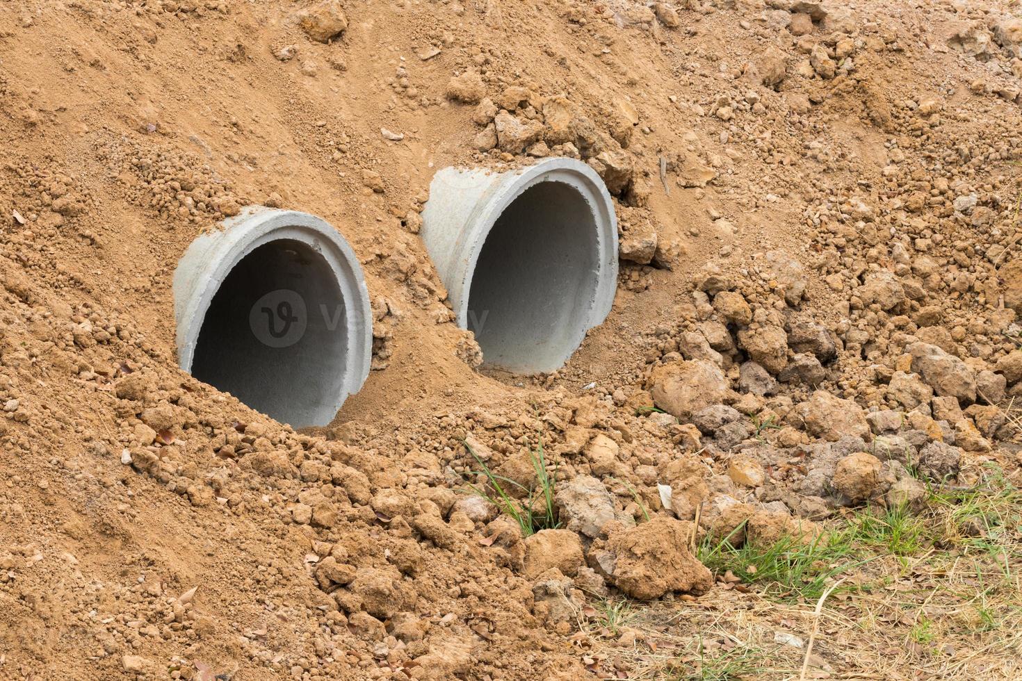 Concrete pipe in dry soil. photo