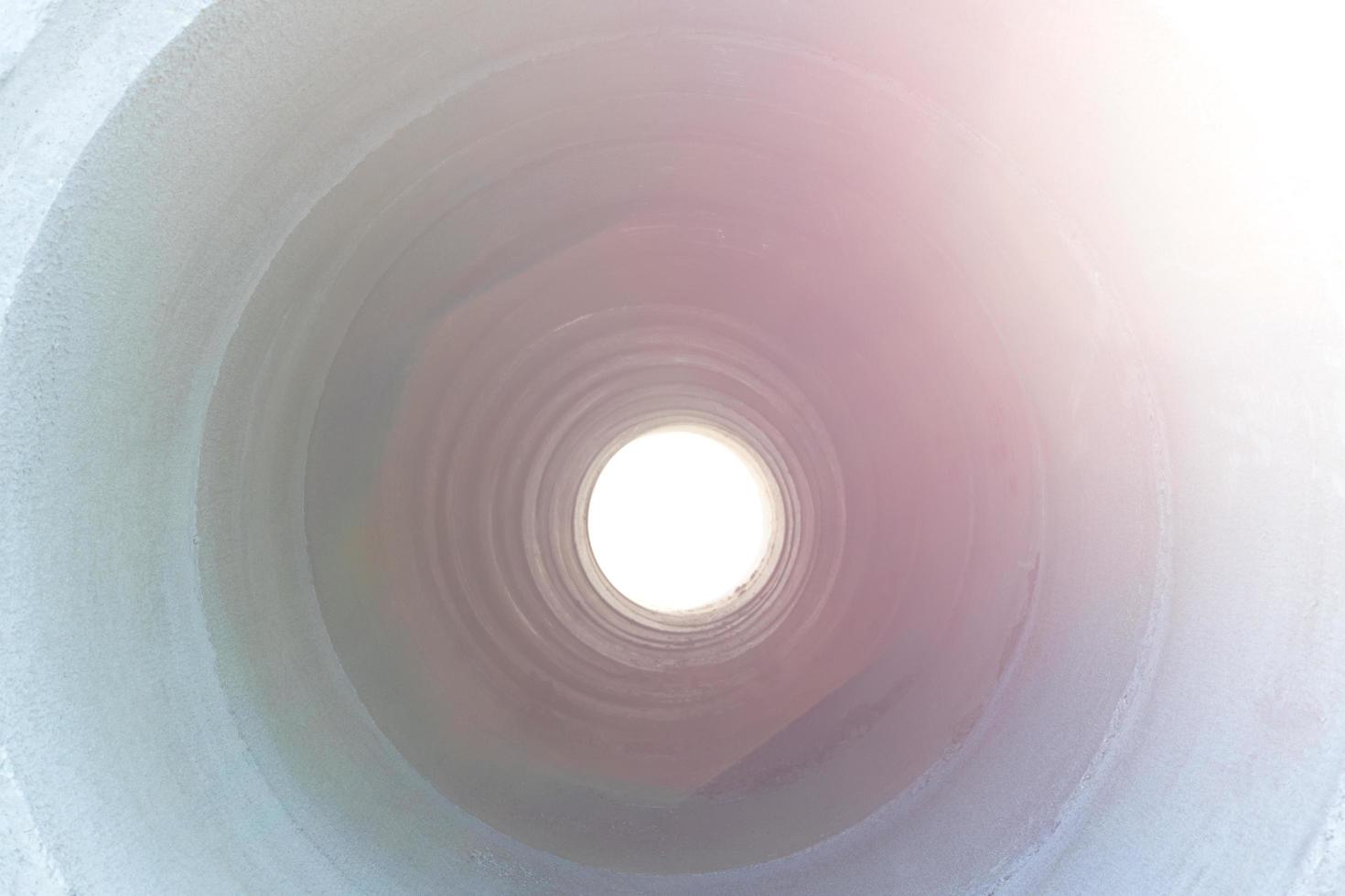 Light through the concrete pipe. photo