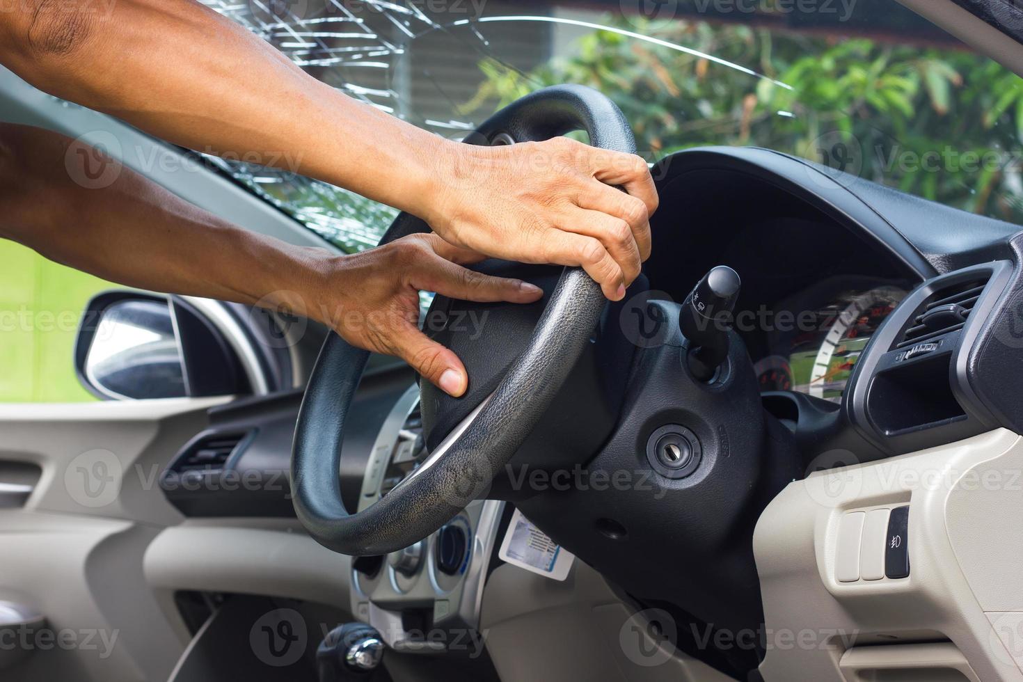 Hands grip the steering wheel accident. photo