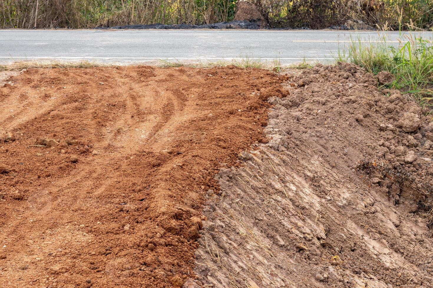 Laterite soil filling the ground near the paved road. photo