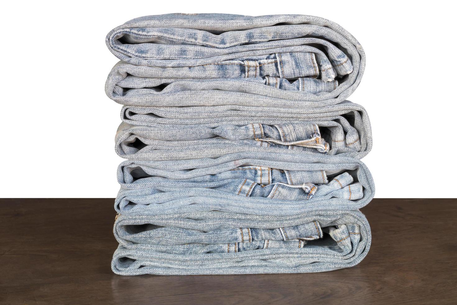 Jeans folded on wooden floor. photo
