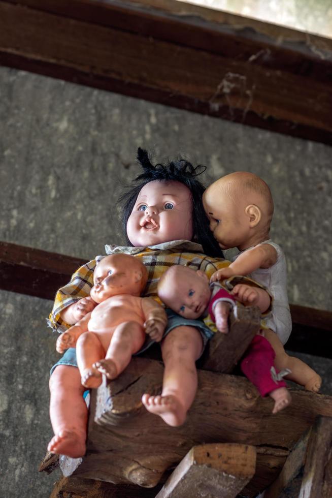 The family of dolls mysterious child on the wood decay. photo