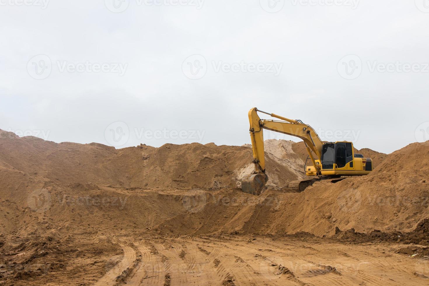 Backhoe on the sand track. photo