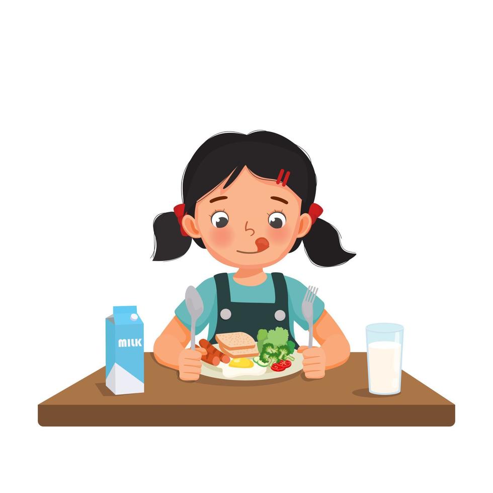 linda niña que se siente emocionada de desayunar con pan, huevo frito, brócoli, verduras, leche con cuchara y tenedor vector