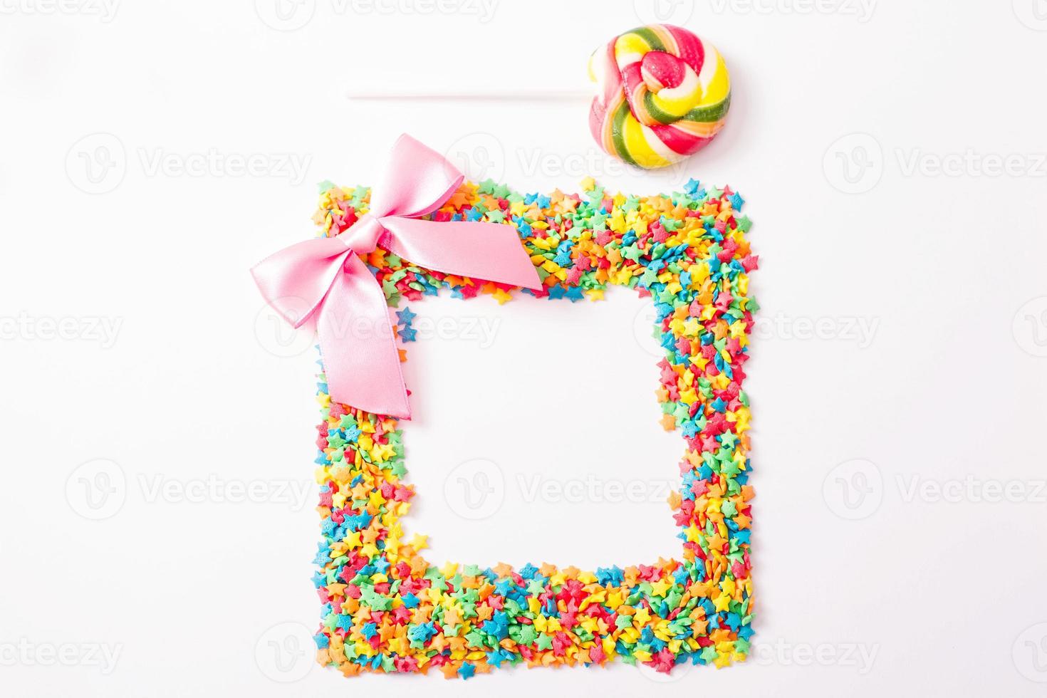 Colorful frame candy, lollipop and sweets isolated on white background. Top view. Selective focus. photo