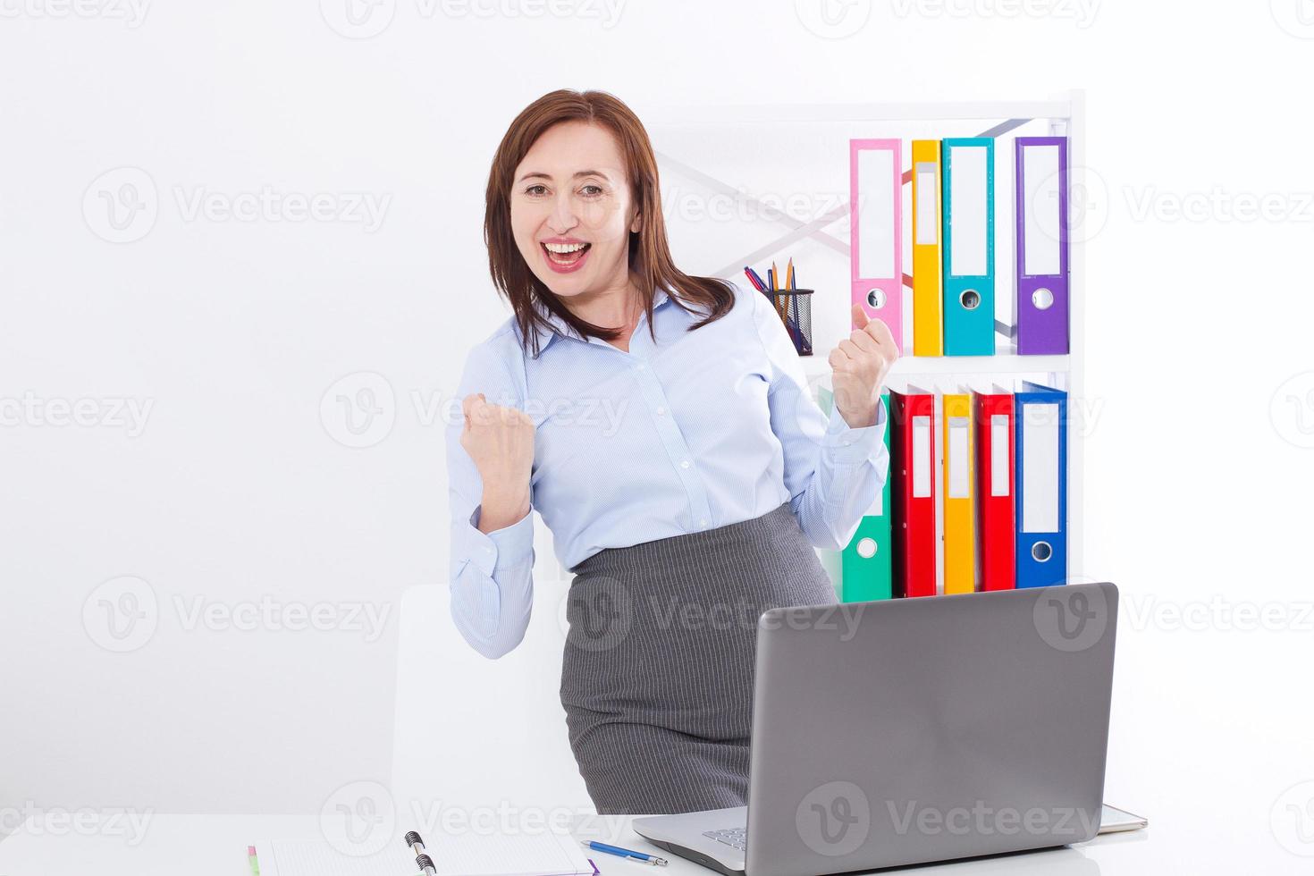 Happy and successful businesswoman raising her arms at office background and celebrating success isolated on white. mock up and copy space. Business concept photo