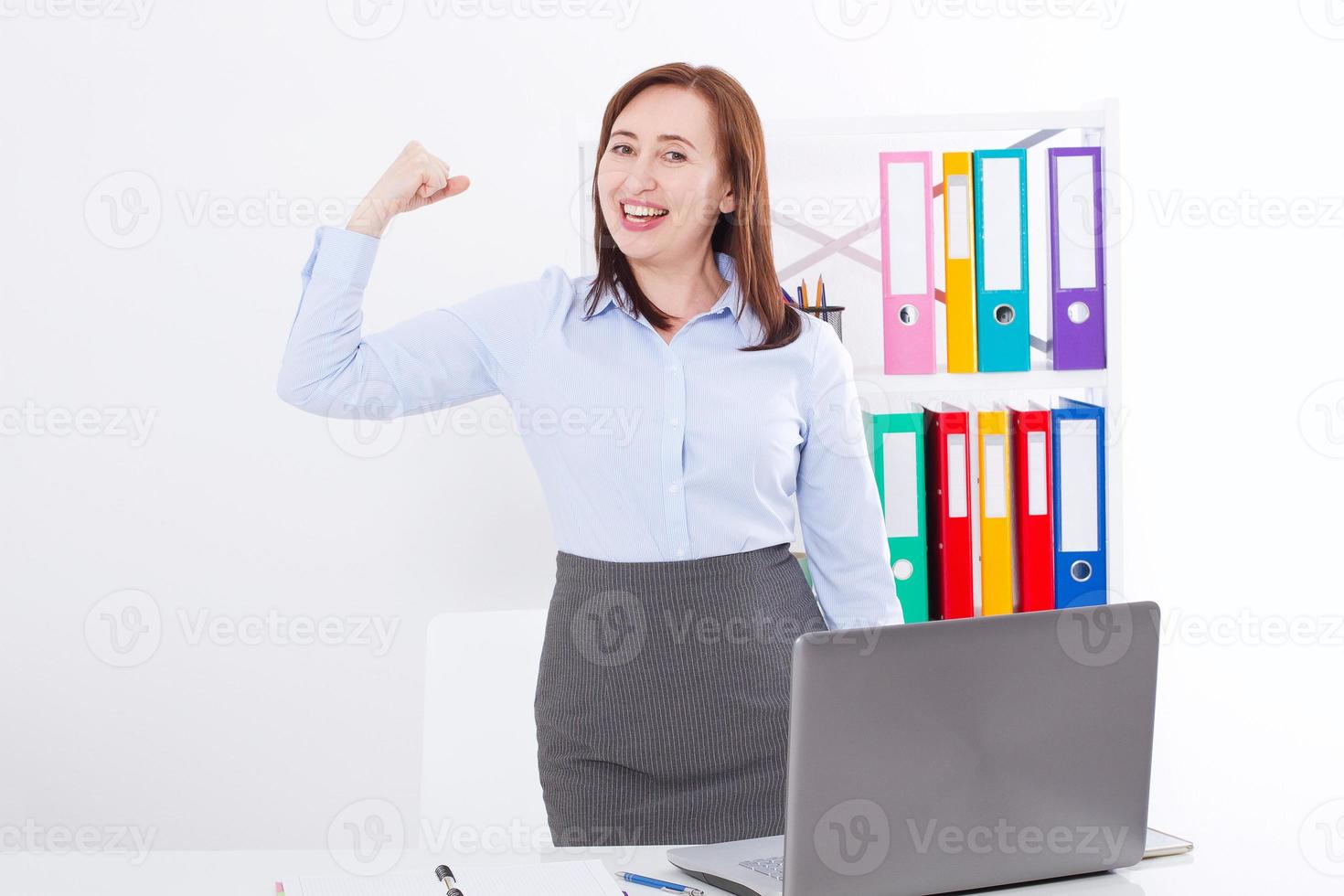 Modern businesswoman at the office background with copy space and mock up. Business success concept. Strong woman at work. photo