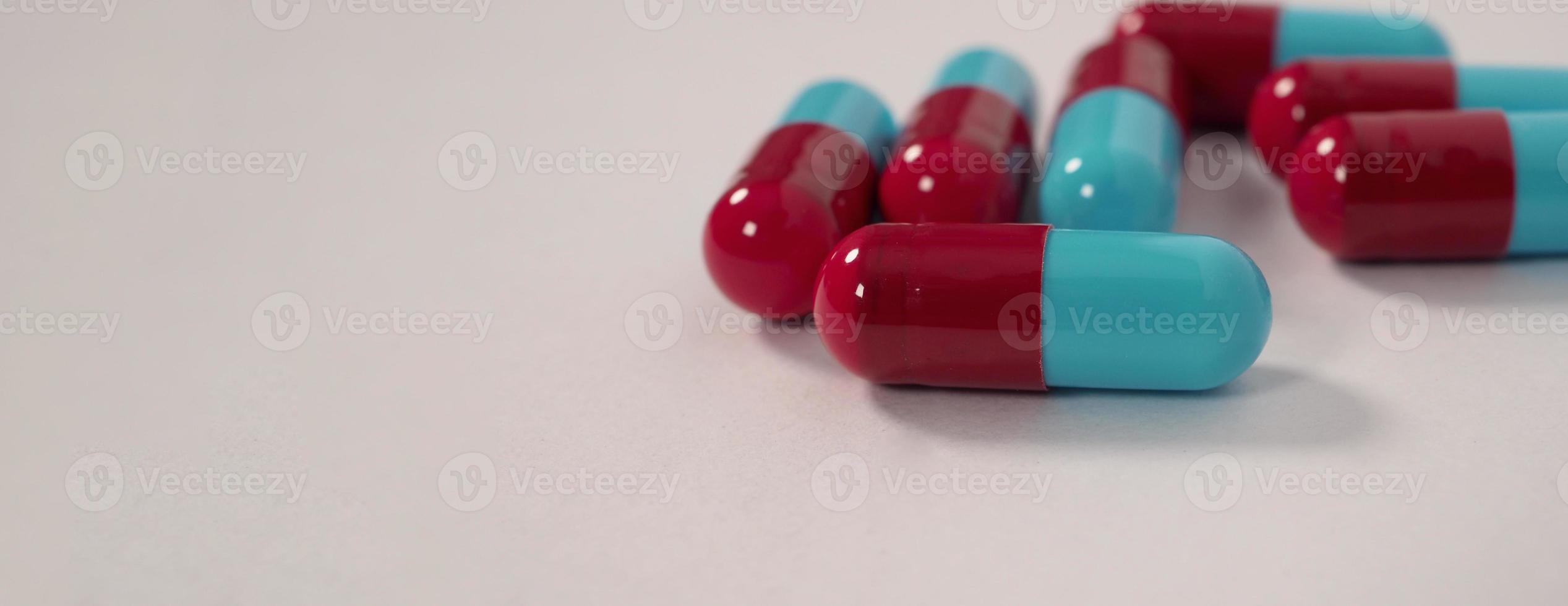 Taking or holding medication pills in hand. Capsule pill on white background. photo