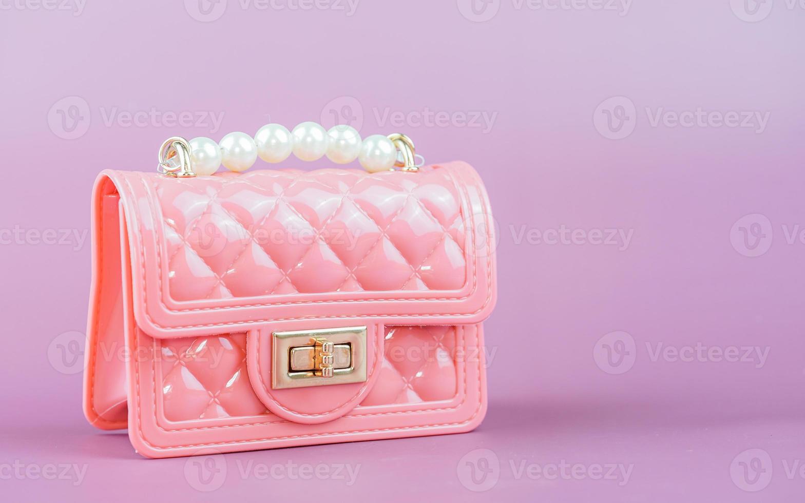 Stylish pink ladies handbag isolated on background. photo