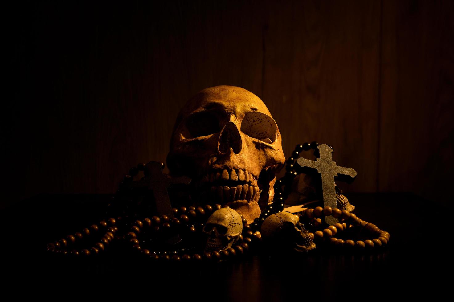 Still life art of a human skull and bead on a black background photo