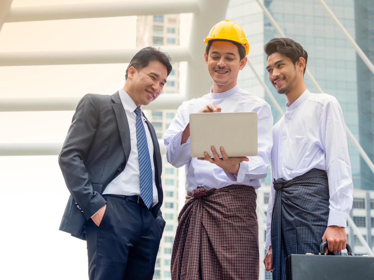 Young Burmese businessmen meet and talk about their business through Internet search, During working hours outside the office photo