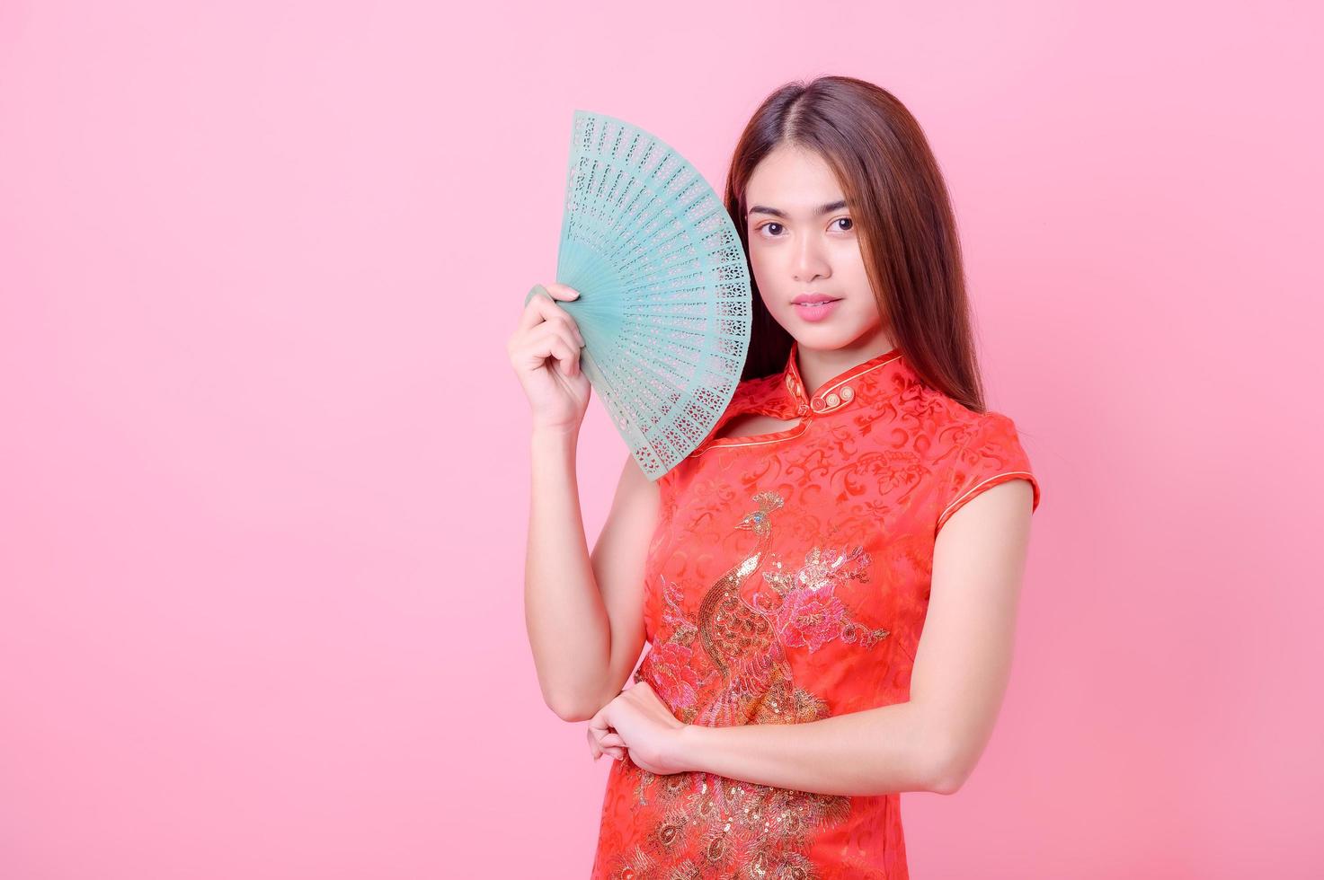 A beautiful Asian woman posed for a picture in Chinese national costume during the Chinese New Year festival photo