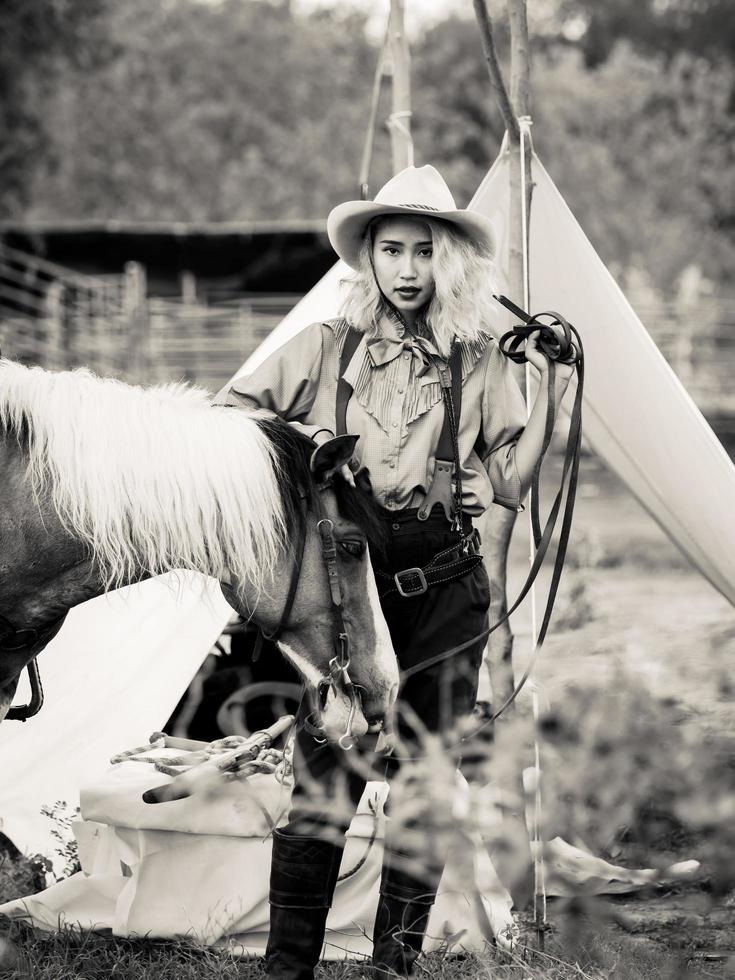 Cowgirl and the horse are deeply bonded to each other in love because of their distressed relationships in a wild outlaw photo