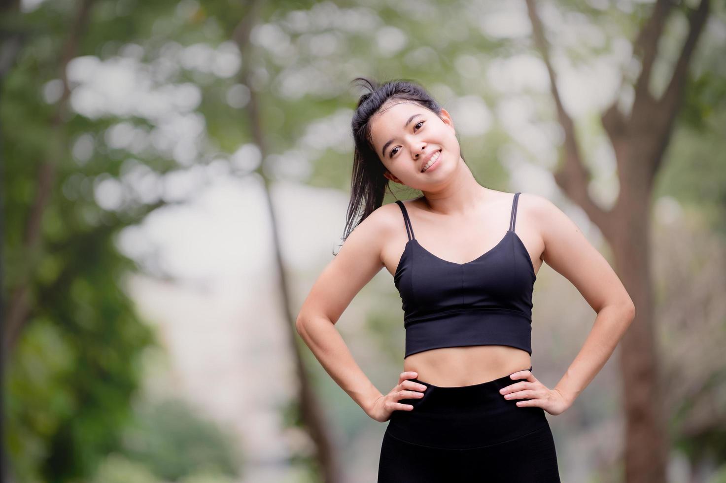 A beautiful Asian woman is warm up, To make the muscles flexible Before going to jogging photo