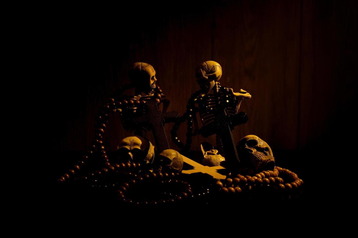 Still life art of a human skull and bead on a black background photo