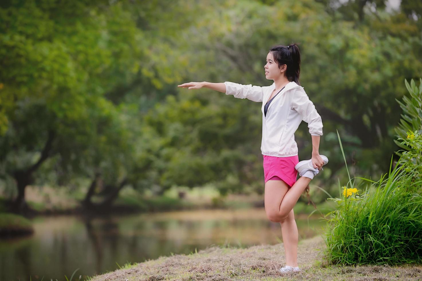 A beautiful Asian woman is warm up, To make the muscles flexible Before going to jogging photo