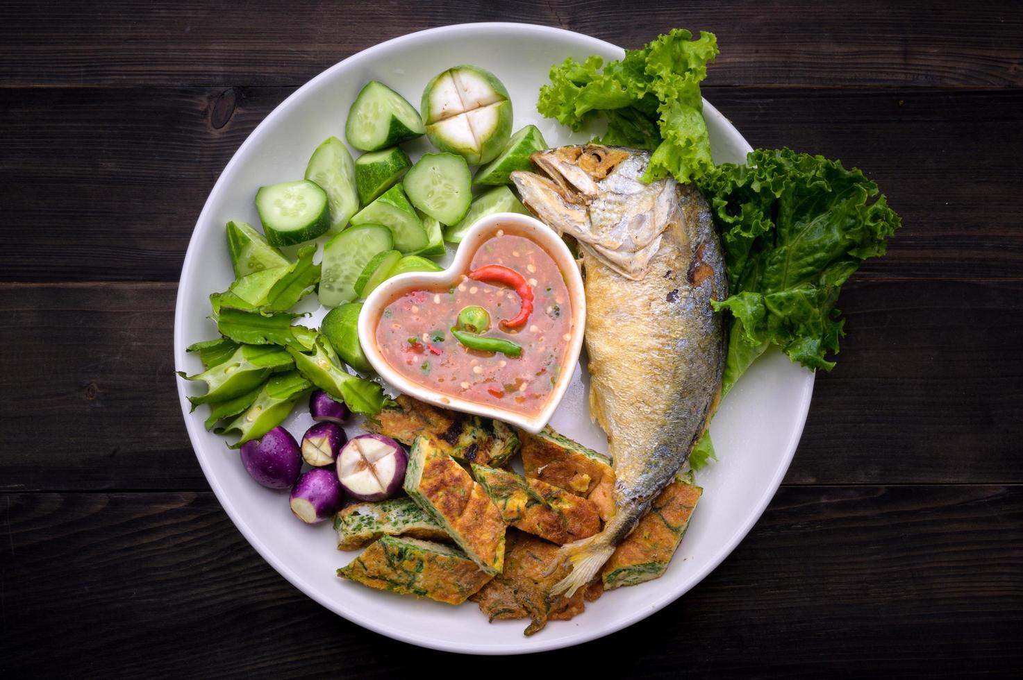 Chili sauce with small shrimps and fried mackerel with a side dish of fried eggs and fresh vegetables is a healthy local Thai dish photo