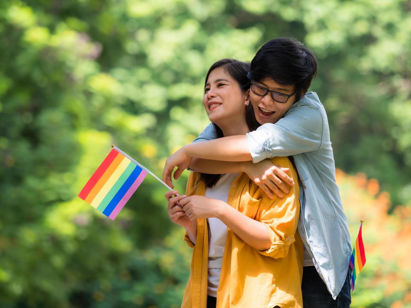 Asian homosexual couples hold an lgbt symbol and embrace each other with love and happiness photo