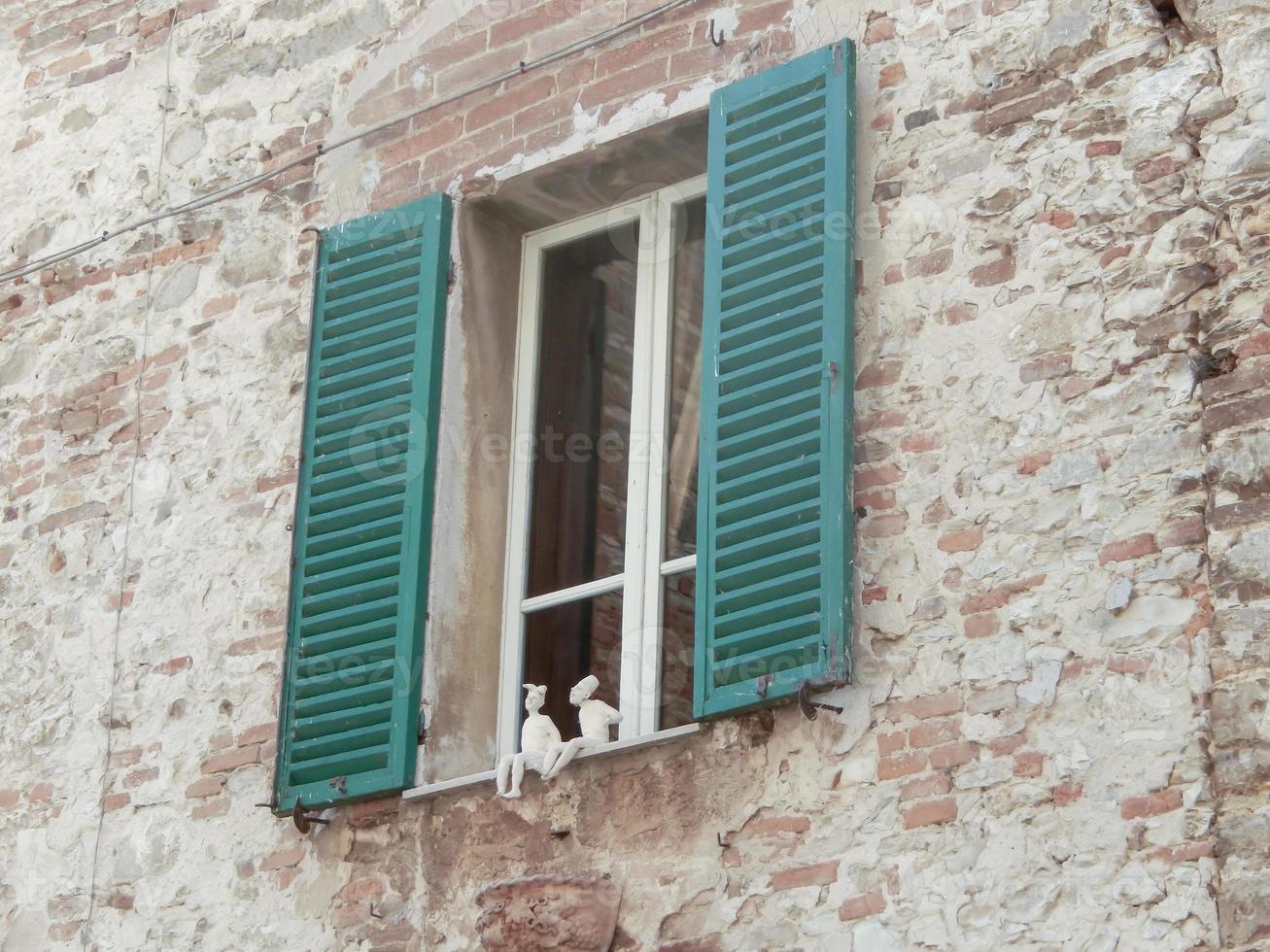 old window in white building photo