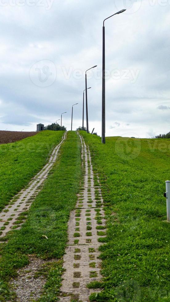 path on a hill with street lamps photo