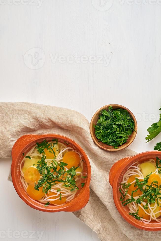 Healthy chicken soup with vegetables and rice noodles, fodmap dash diet, top view copy space photo