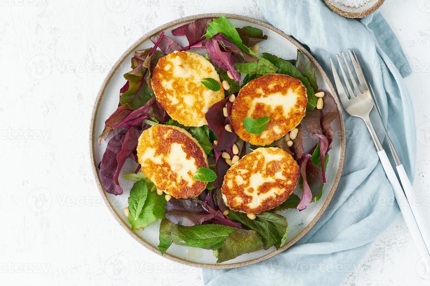 Cyprus fried halloumi with salad mix, beet tops. Lchf, pegan, fodmap, paleo, scd, keto photo