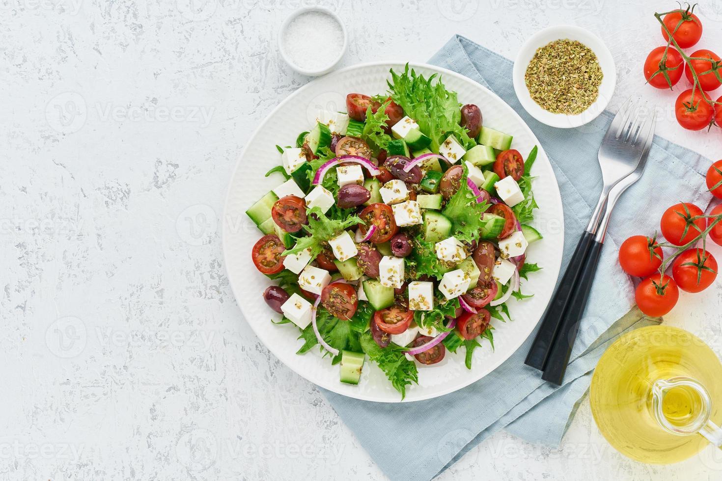 Greek Salad with feta and tomatoes, dieting food on white background copy space top view photo