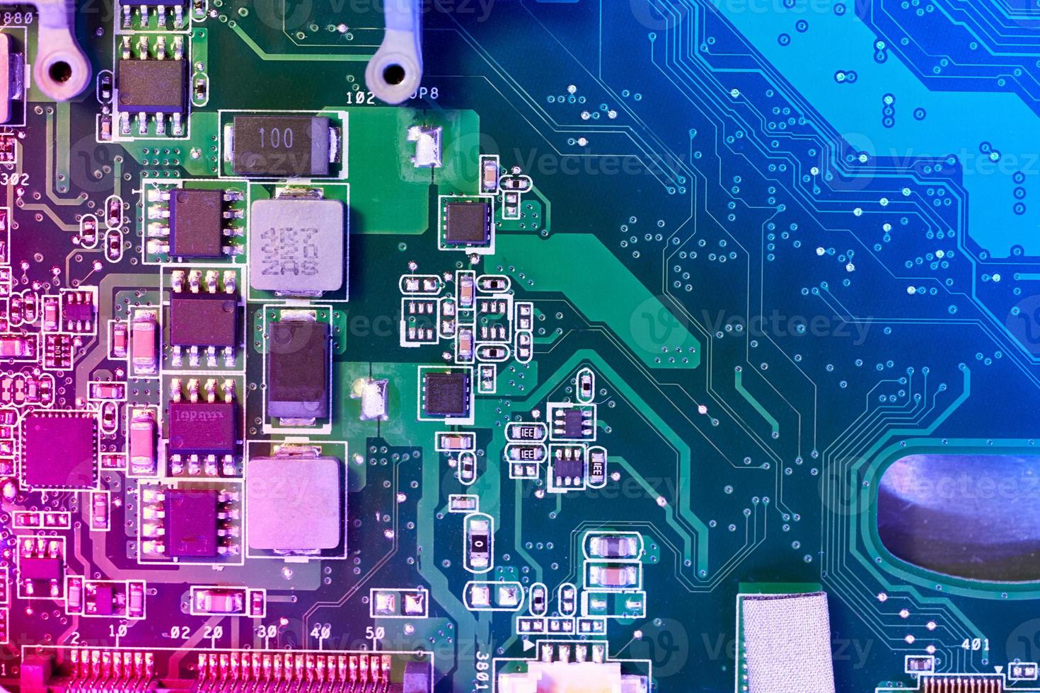 Computer motherboard background with blur neon multicolor glow photo