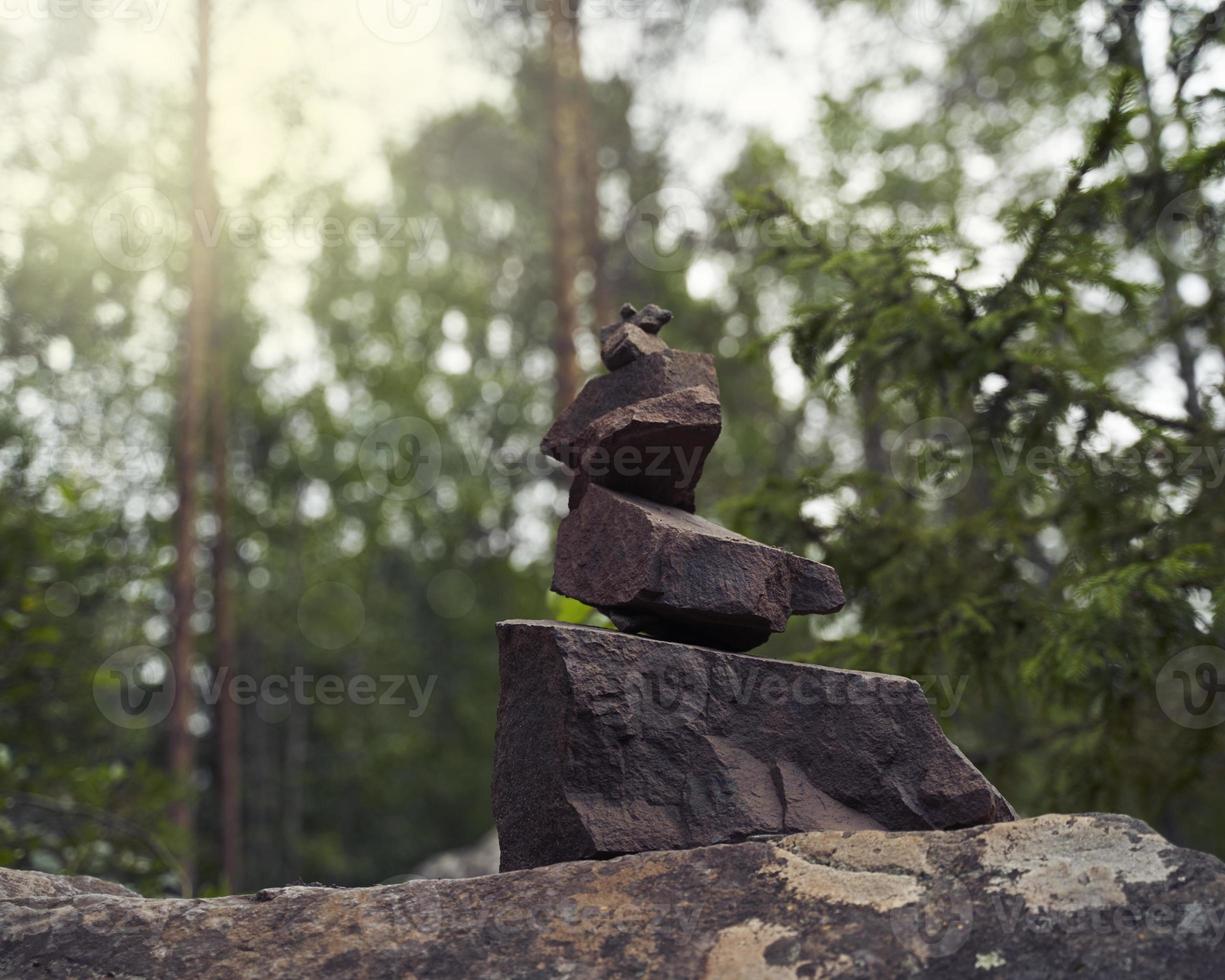 Pyramid of stones, a symbol of the wild Northern nature of Karelia. Coniferous forest photo