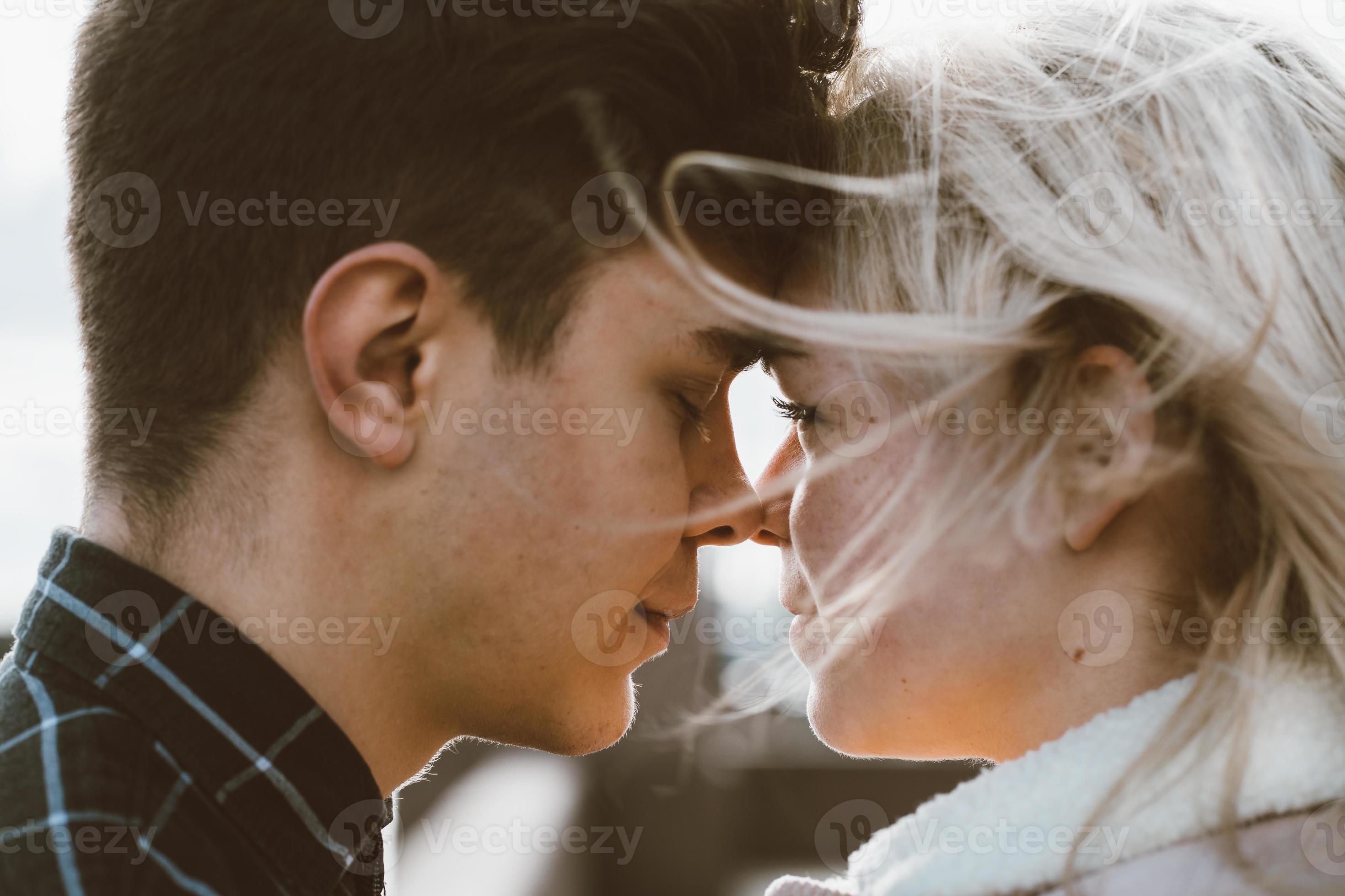 The boy looks tenderly at girl and wants to kiss. Concept of teenage love  and first kiss 7542624 Stock Photo at Vecteezy