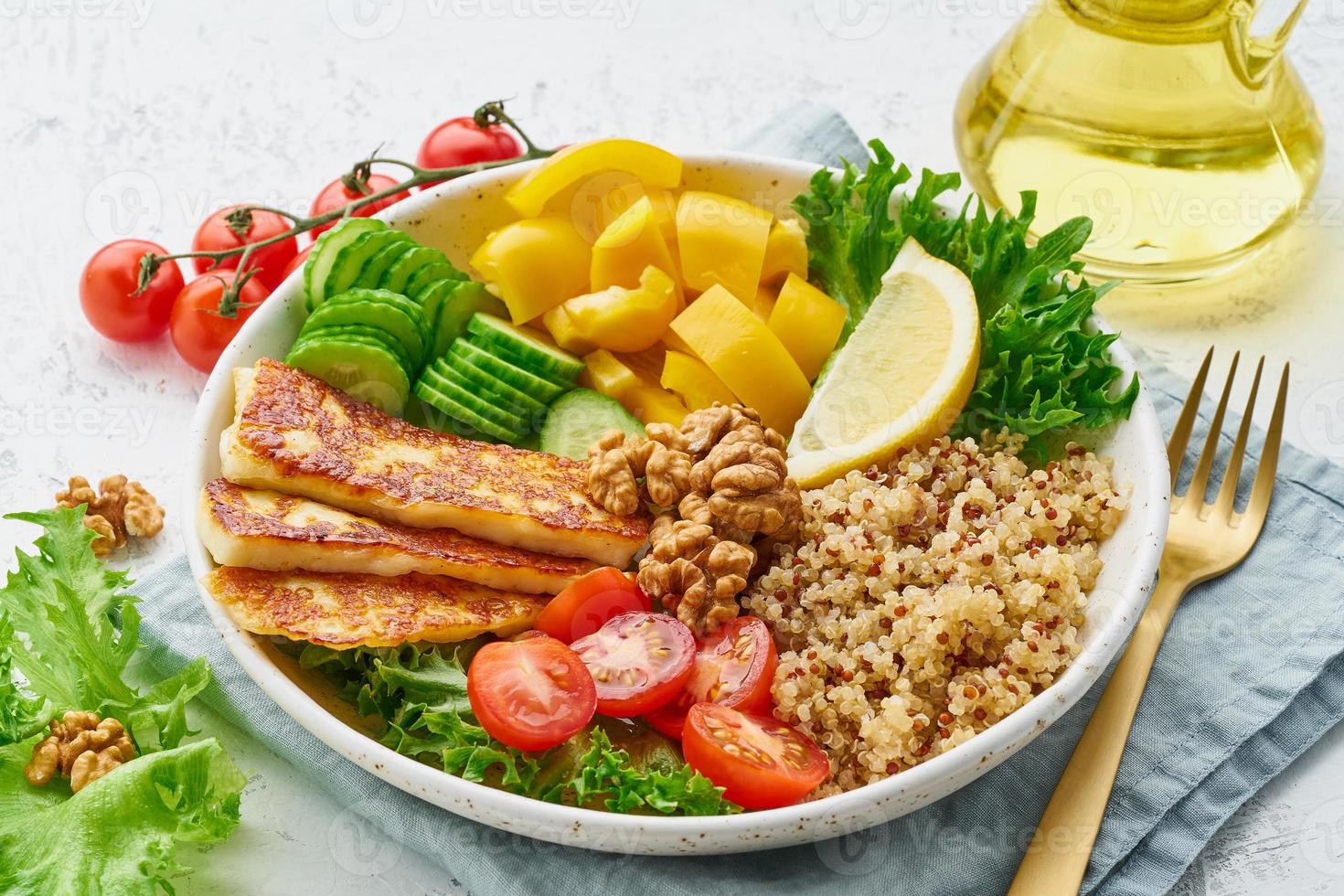 Buddha bowl with halloumi, salad lettuce, quinoa, balanced food, white background, closeup photo