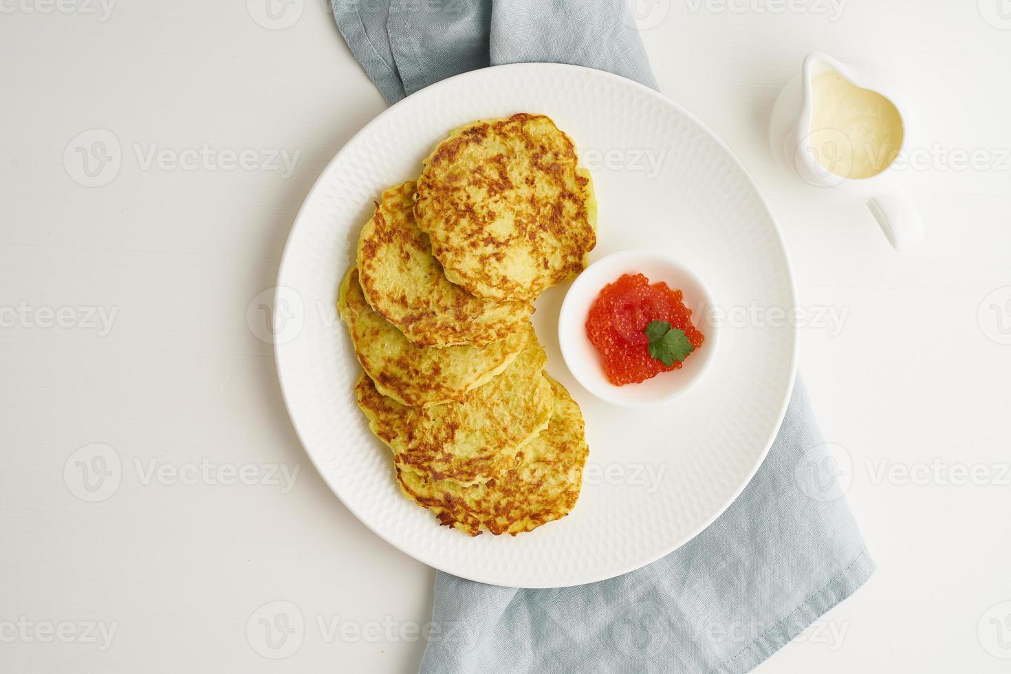 Zucchini pancakes with potato and red caviar, fodmap keto diet top view photo