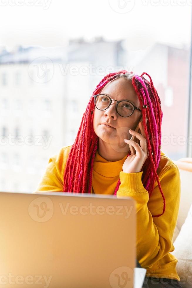 Digital nomad concept. Girl freelancer remotely working on laptop in cafe, coworking. photo