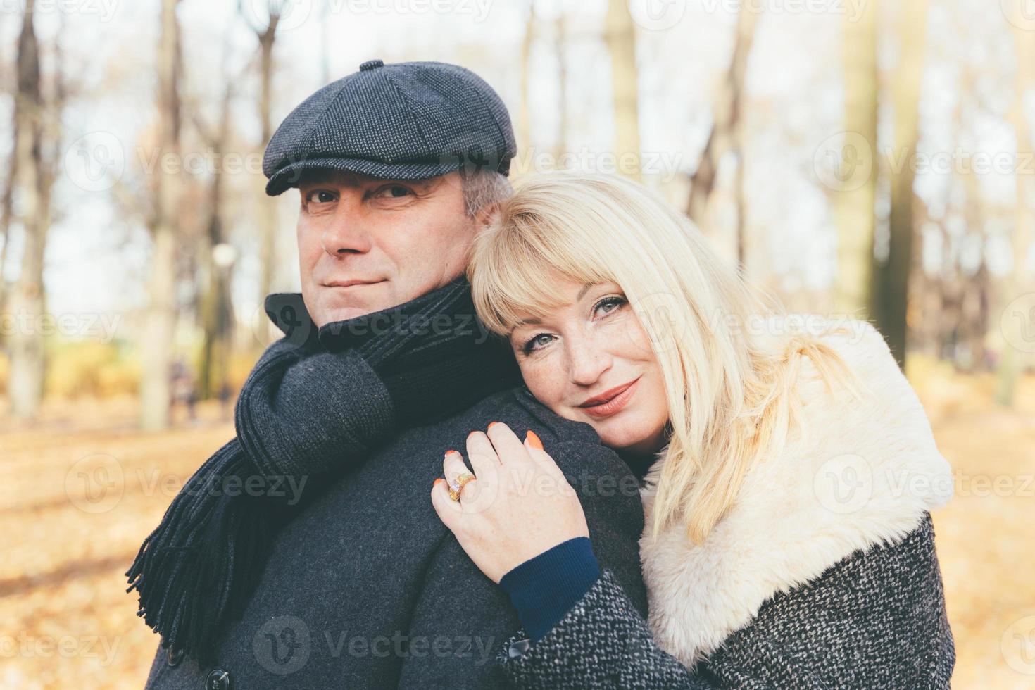 Happy blonde mature woman and handsome middle-aged brunette man photo