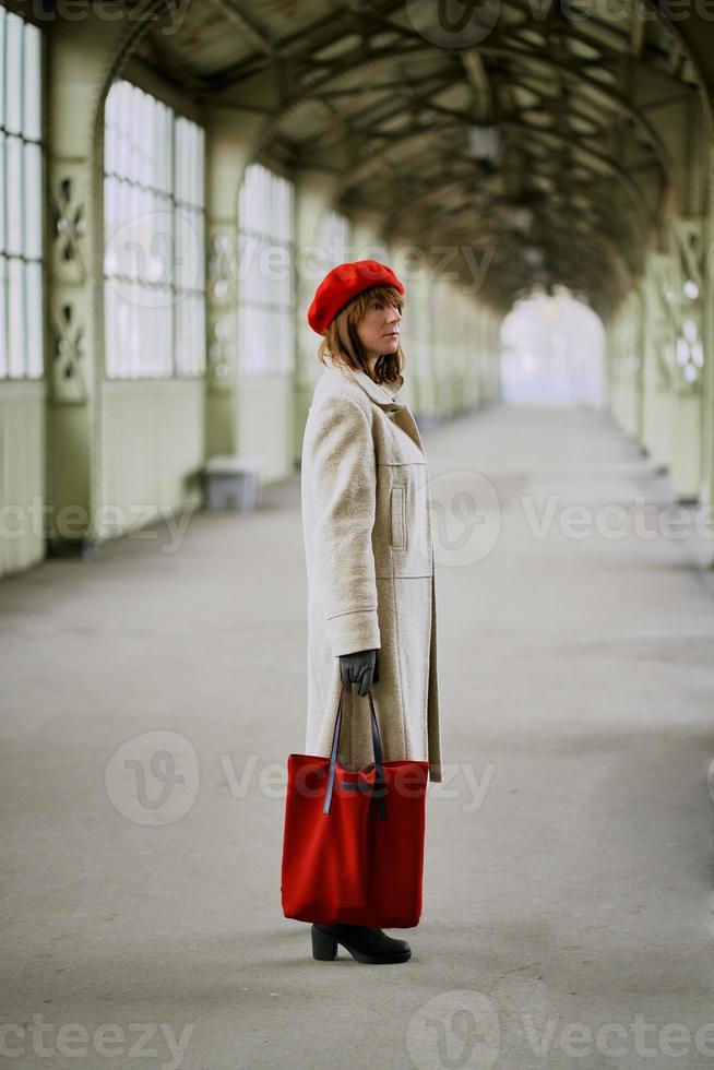 Railway station. Beautiful girl is waiting for train. Woman travels light. Middle-aged lady photo