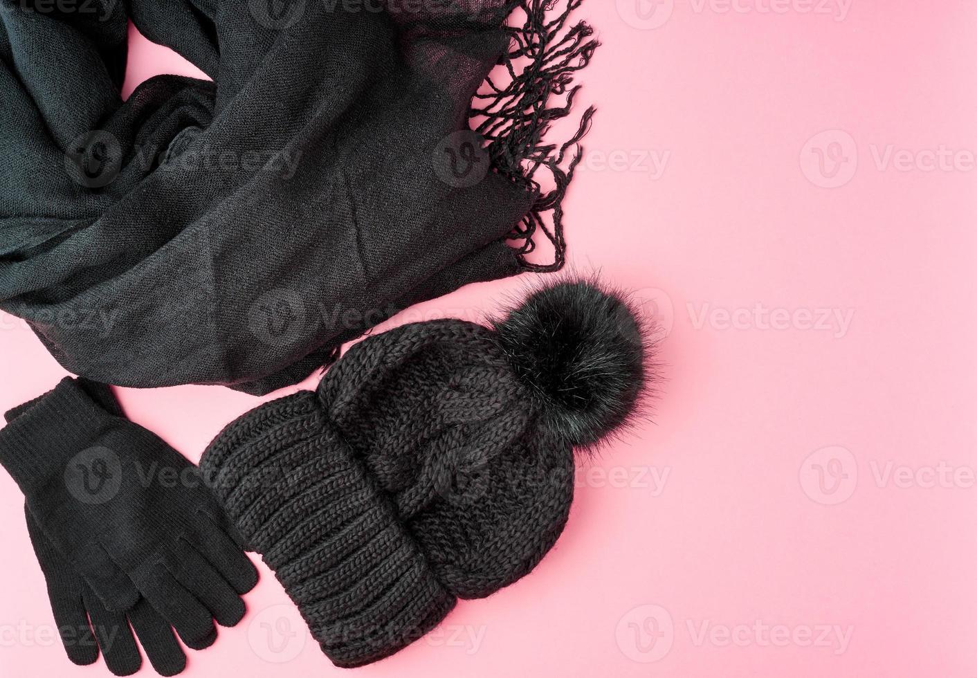 Flat lay winter or autumn warm woman accessories - black knitted scarf, hat, photo