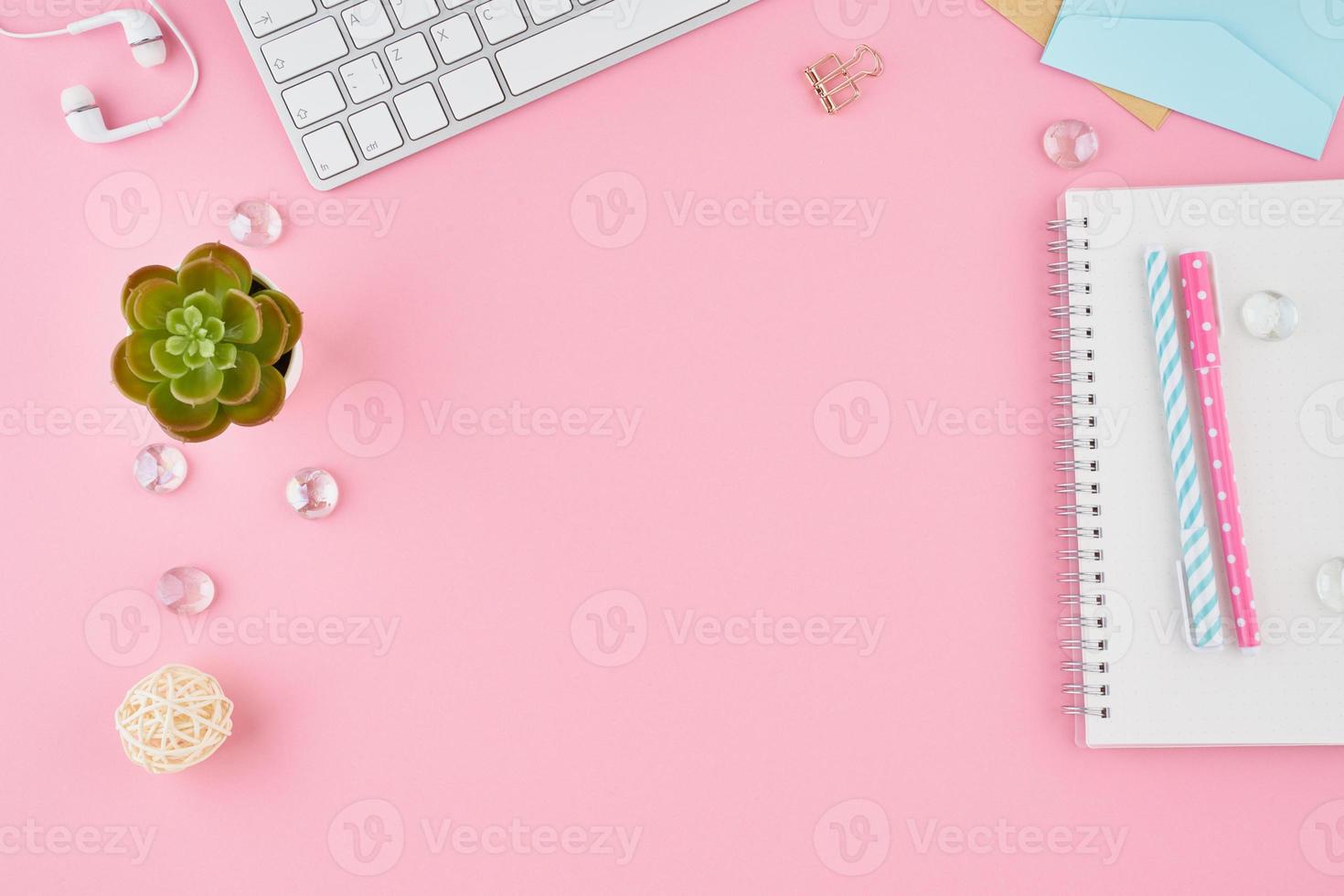 Part of blank notepad page in bullet journal on bright pink office desktop photo