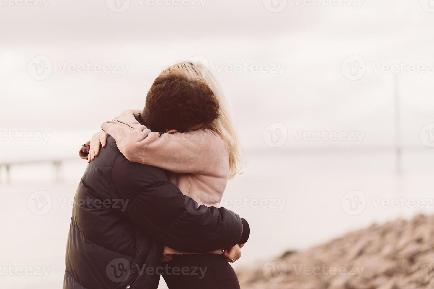 Teenage love concept. Cute brunette guy  young blonde girl photo